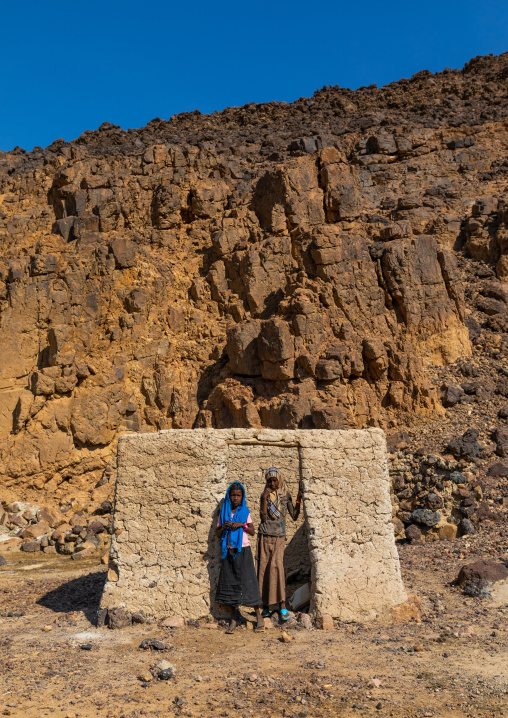 Bisharin nomad girls collecting salt in Atrun crater, Bayuda desert, Atrun, Sudan