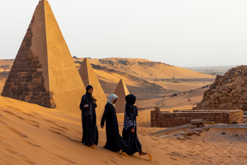 Sudanese women visiting the pyramids of the kushite rulers at Meroe, Northern State, Meroe, Sudan