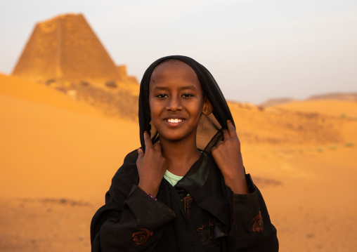 Portrait of sudanese girl visiting the pyramids of the kushite rulers at Meroe, Northern State, Meroe, Sudan