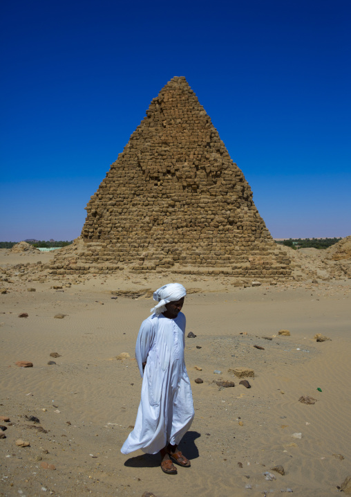 Sudan, Nubia, Nuri, sudanese man in front of the royal pyramids of napata