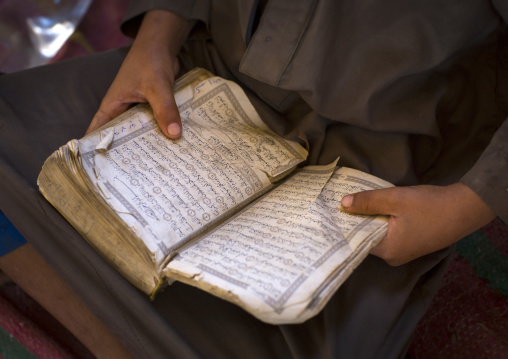 Sudan, Kassala State, Kassala, rashaida tribe kid reading quran in a coranic school