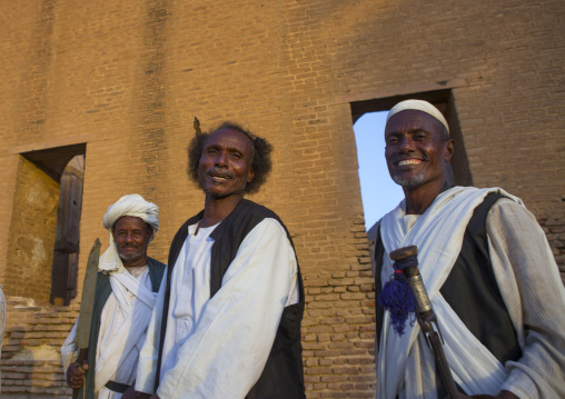 Sudan, Kassala State, Kassala, beja tribe men dancing in front of the khatmiyah mosque at the base of the taka mountains