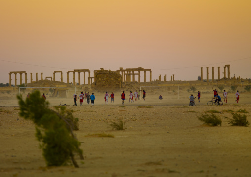 Men Playing Football In The Ancient Roman City, Palmyra, Syrian Desert, Syria