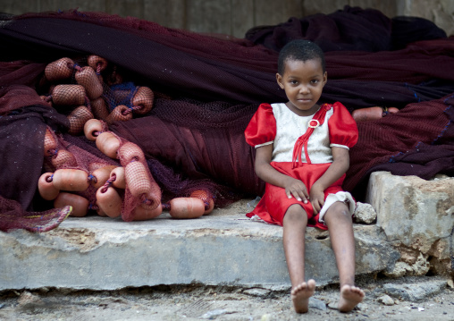 Tanzanian girl in front of nets, Tanzania