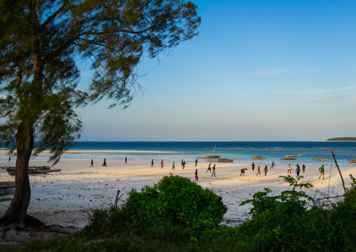 Tanzania, Zanzibar, Matemwe, children playing football on muyuni sandy beach