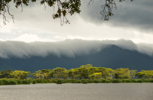 Tanzania, Arusha Region, Ngorongoro Conservation Area, clouds over landscape and mountain range