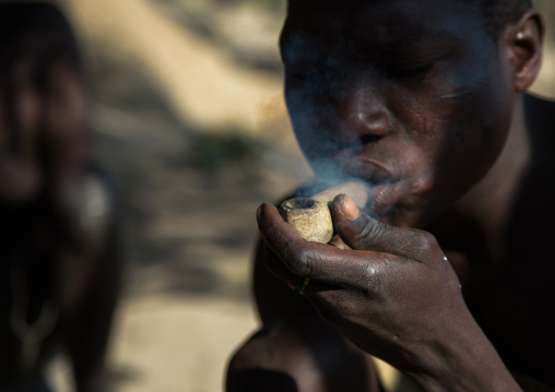 Tanzania, Serengeti Plateau, Lake Eyasi, hadzabe tribe man smoking cannabis