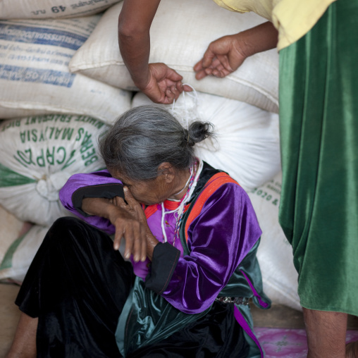 Old woman crying during the lisu tribe string ceremony, Ban nam rin village, Thailand