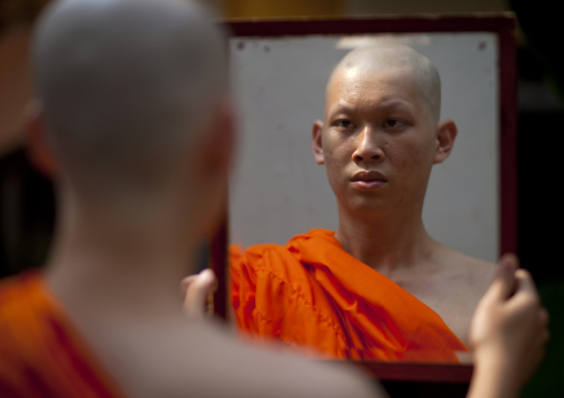 Novice looking at himself in a mirror, Bangkok thailand