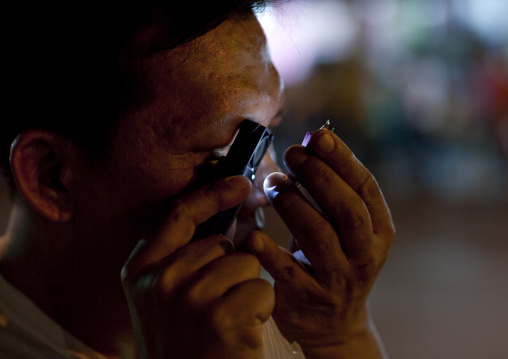 Choosing amulet in the street, Bangkok, Thailand