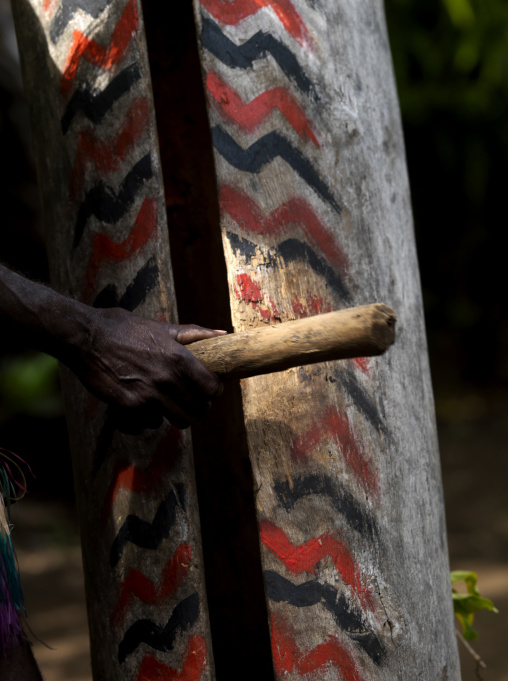 Small Nambas tribesman beating on a slit gong drum during the palm tree dance, Malekula island, Gortiengser, Vanuatu