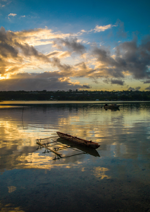 Dugout boat on a quiet sea in Erakor beach, Shefa Province, Efate island, Vanuatu