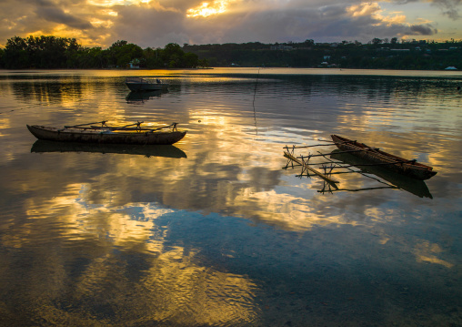 Dugout boats on a quiet sea in Erakor beach, Shefa Province, Efate island, Vanuatu