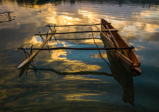 Dugout boat on a quiet sea in Erakor beach, Shefa Province, Efate island, Vanuatu