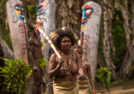 Small Nambas tribeswomen dancing in front of slit gong drums during the palm tree dance, Malekula island, Gortiengser, Vanuatu