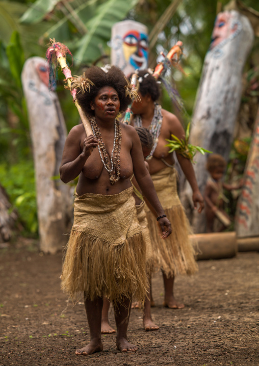 Small Nambas tribeswomen dancing in front of slit gong drums during the palm tree dance, Malekula island, Gortiengser, Vanuatu