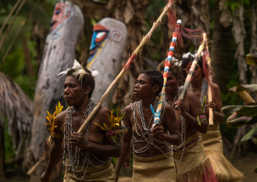 Small Nambas tribeswomen dancing in front of slit gong drums during the palm tree dance, Malekula island, Gortiengser, Vanuatu