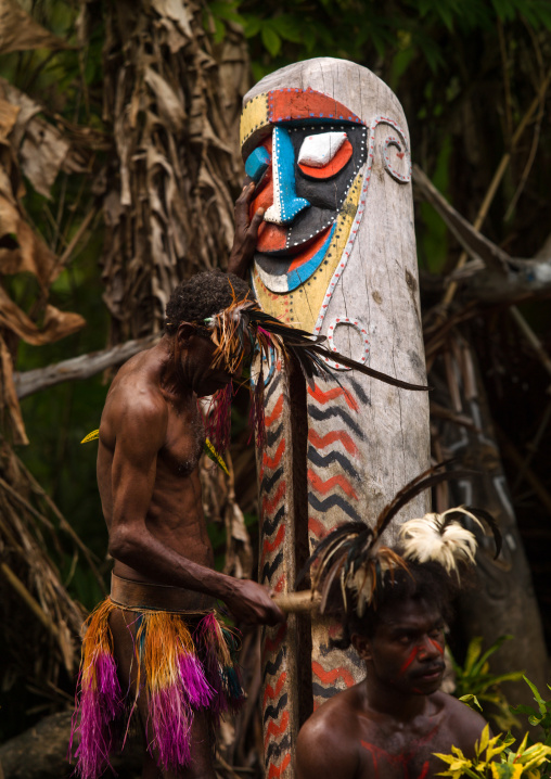 Small Nambas tribesman beating on a slit gong drum during the palm tree dance, Malekula island, Gortiengser, Vanuatu