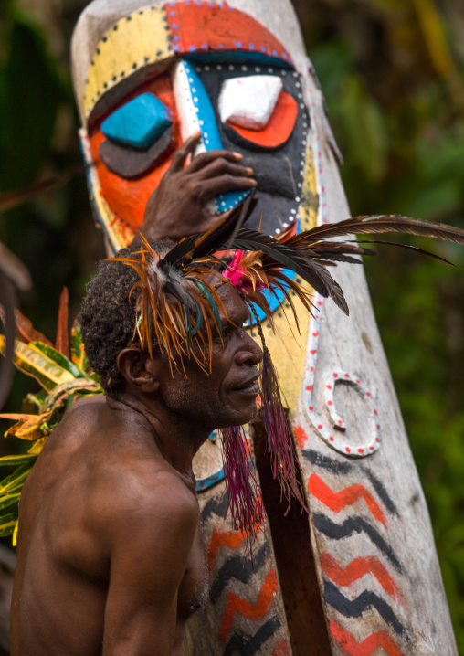 Small Nambas tribesman beating on a slit gong drum during the palm tree dance, Malekula island, Gortiengser, Vanuatu