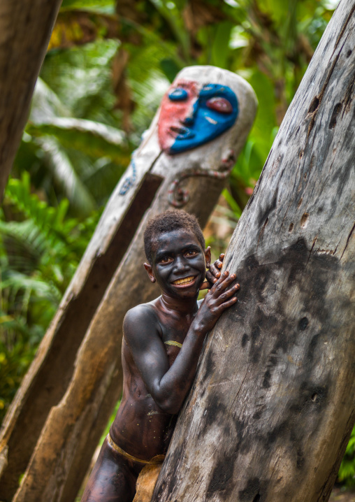 Small Nambas tribe boy in front of a giant slit gong drum during a ceremony, Malekula island, Gortiengser, Vanuatu