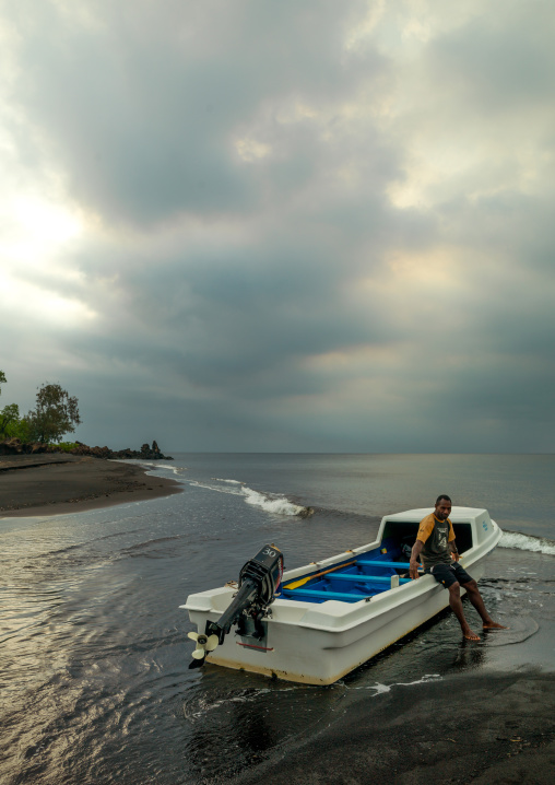 Boat stopped on the hot springs coming from the volcano along the coast, Malampa Province, Ambrym island, Vanuatu