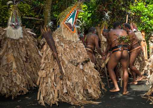 Tribesmen dressed in colorful masks and costumes made from the leaves of banana trees performing a Rom dance, Ambrym island, Fanla, Vanuatu