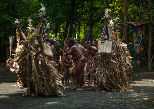 Tribesmen dressed in colorful masks and costumes made from the leaves of banana trees performing a Rom dance, Ambrym island, Fanla, Vanuatu