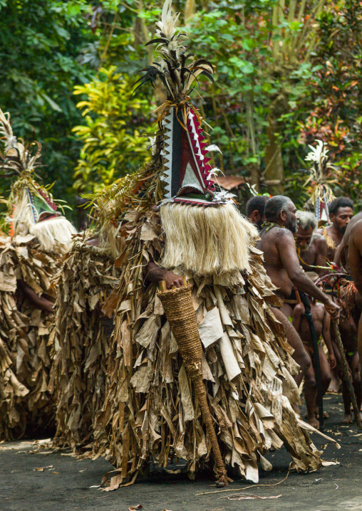 Tribesmen dressed in colorful masks and costumes made from the leaves of banana trees performing a Rom dance, Ambrym island, Fanla, Vanuatu