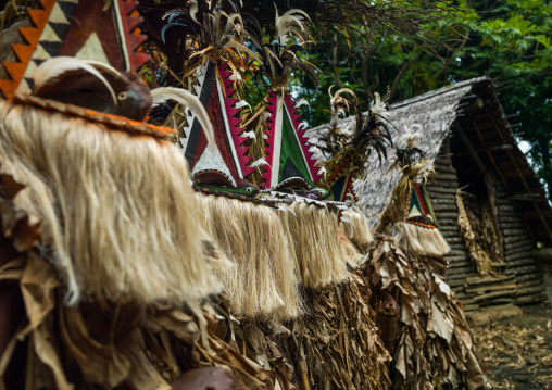 Tribesmen dressed in colorful masks and costumes made from the leaves of banana trees performing a Rom dance, Ambrym island, Fanla, Vanuatu