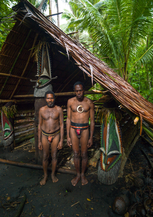 Portrait of chieftain Sekor and his father in front of a painted grade statue, Ambrym island, Olal, Vanuatu