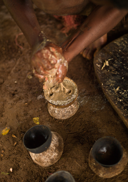 Woman preparing and squeezing kava to drink at a traditional ceremony, Sanma Province, Espiritu Santo, Vanuatu