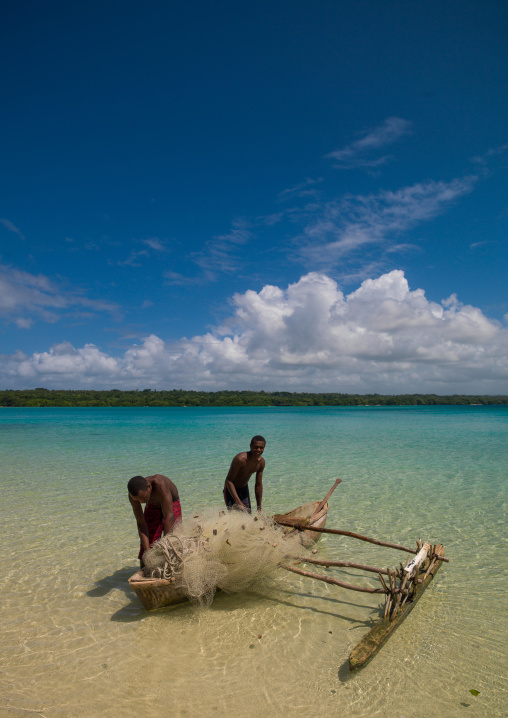 Young boys of the Ni-Vanuatu people in their dugout, Sanma Province, Espiritu Santo, Vanuatu