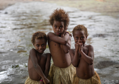 Three girls in traditional grass skirts, Tanna island, Yakel, Vanuatu