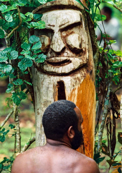 Tribesman beating a drum during a ceremony in the jungle, Malampa province, Malekula island, Vanuatu