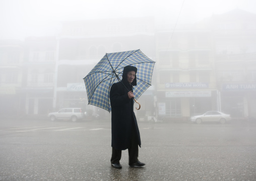 Man under an umbrella in sapa, Vietnam