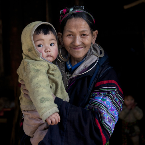 Black hmong grandmother with her grandson in the arms, Sapa, Vietnam