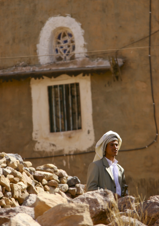 Young Man Passing Behind A Heap Of Stones, Ina, Yemen