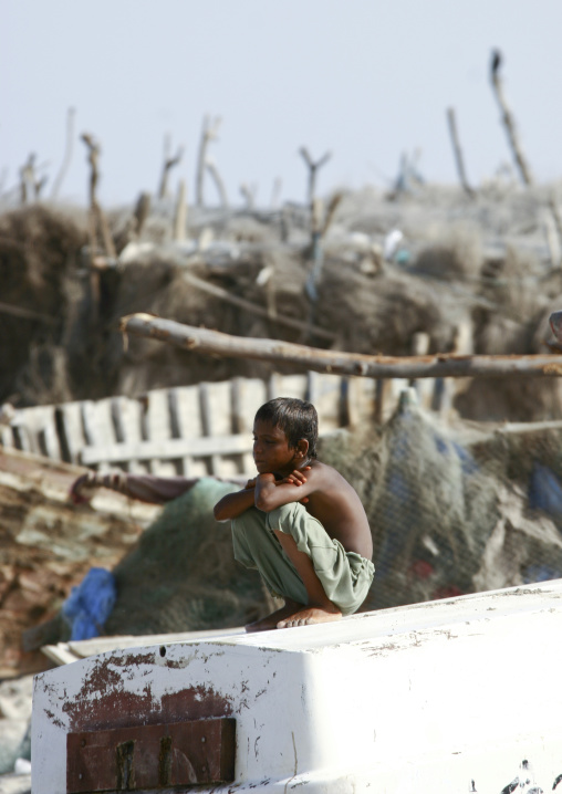 Dreaming Boy Squatting In Al Khukaha Harbor, Yemen